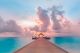 Colorful Sky and Clouds with Wooden Jetty and Over Water Bungalow Canvas Print