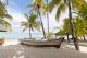 Old Wooden Fishing Boat on a Tropical Paradise Island and Palm Trees Canvas Print